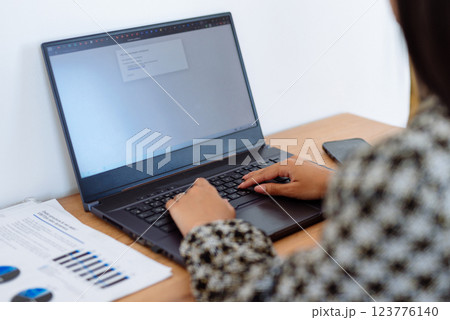 Woman sitting at desk typing remote working from home. 123776140