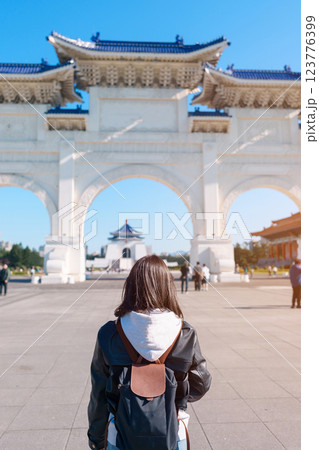 woman traveler visiting in Taiwan, female Tourist sightseeing at National Chiang Kai shek Memorial or Hall Freedom Square, Taipei City. Popular landmark and attractions. Asia Travel concept 123776399
