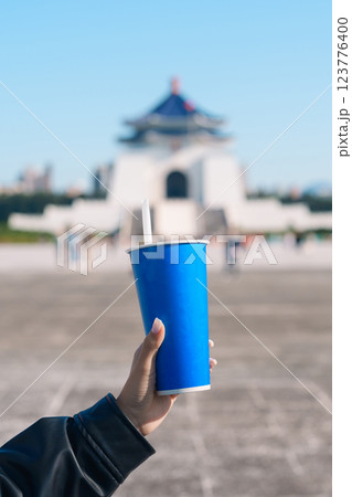 woman hand holding Pearl bubble milk tea glasses. traveler at National Chiang Kai shek Memorial, a famous beverages in Taipei, Taiwan woman hand holding Pearl bubble milk tea glasses. traveler at National Chiang Kai shek Memorial, a famous beverages in Taipei, Taiwan 123776400