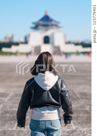 woman traveler visiting in Taiwan, female Tourist sightseeing at National Chiang Kai shek Memorial or Hall Freedom Square, Taipei City. Popular landmark and attractions. Asia Travel concept 123776401