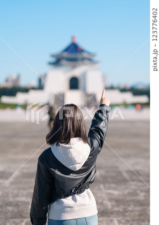 woman traveler visiting in Taiwan, female Tourist sightseeing at National Chiang Kai shek Memorial or Hall Freedom Square, Taipei City. Popular landmark and attractions. Asia Travel concept 123776402