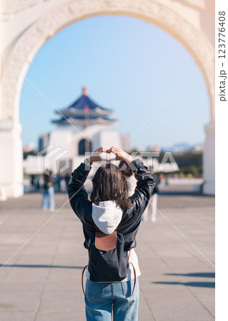 woman traveler visiting in Taiwan, female Tourist sightseeing at National Chiang Kai shek Memorial or Hall Freedom Square, Taipei City. Popular landmark and attractions. Asia Travel concept 123776408