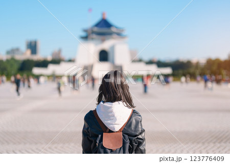 woman traveler visiting in Taiwan, female Tourist sightseeing at National Chiang Kai shek Memorial or Hall Freedom Square, Taipei City. Popular landmark and attractions. Asia Travel concept 123776409