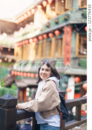 woman traveler visiting in Taiwan, female Tourist with backpack sightseeing at Jiufen Old Street village with Tea House background. Popular landmarks and attractions near Taipei City. Travel concept 123776416