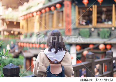 woman traveler visiting in Taiwan, female Tourist with backpack sightseeing at Jiufen Old Street village with Tea House background. Popular landmarks and attractions near Taipei City. Travel concept 123776418