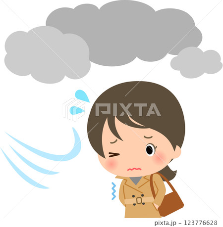 曇天の下を寒そうに歩くトレンチコートの女性 123776628