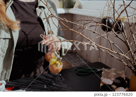 Unrecognizable woman creating Easter holiday decoration from egg shell. Diy do it yourself step by step instruction. Crafting preparation Unrecognizable woman creating Easter holiday decoration from egg shell. Diy do it yourself step by step instruction. Crafting preparation 123776820