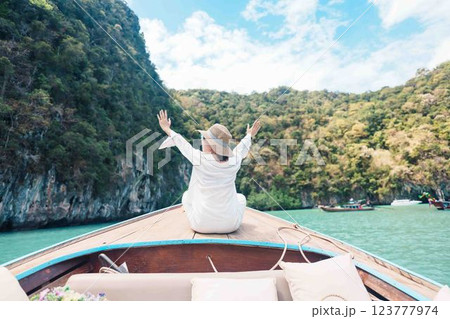 Happy Woman tourist in private longtail boat trip to koh Hong lagoon island at Krabi, Thailand. landmark, tropical destination, southeast Asia Travel, summer vacation, wanderlust and holiday concept Happy Woman tourist in private longtail boat trip to koh Hong lagoon island at Krabi, Thailand. landmark, tropical destination, southeast Asia Travel, summer vacation, wanderlust and holiday concept 123777974