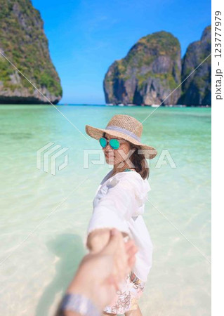 Couple tourist traveling and sightseeing in Krabi, Thailand. happy traveller enjoy at Maya Bay beach on Phi Phi island. Honeymoon trip, destination, Southeast Asia Travel, vacation and holiday concept 123777979