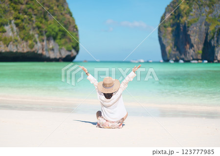 Woman tourist traveling and sightseeing in Krabi, Thailand, happy traveller enjoy at Maya Bay beach on Phi Phi island, Popular paradise island, destination, Southeast Asia Travel, vacation and holiday 123777985