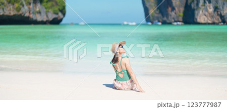 Woman tourist traveling and sightseeing in Krabi, Thailand, happy traveller enjoy at Maya Bay beach on Phi Phi island, Popular paradise island, destination, Southeast Asia Travel, vacation and holiday 123777987