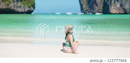Woman tourist traveling and sightseeing in Krabi, Thailand, happy traveller enjoy at Maya Bay beach on Phi Phi island, Popular paradise island, destination, Southeast Asia Travel, vacation and holiday 123777988