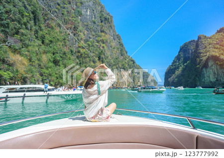 Woman tourist on boat trip, happy traveller relaxing at Pileh lagoon on Phi Phi island, Krabi, Thailand. Exotic landmark, destination Southeast Asia Travel, summer vacation and holiday concept 123777992