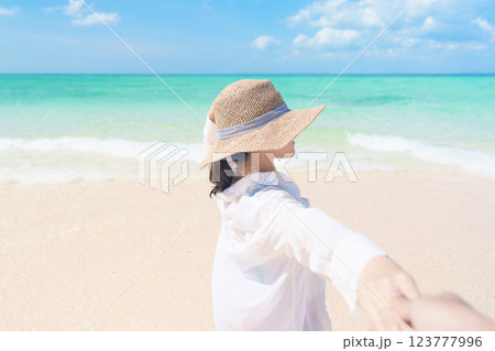 couple tourist relaxing and enjoying on beach, happy traveller looking beautiful sea view on tropical island. Honeymoon, tropical destination, southeast Asia Travel, summer vacation and wanderlust 123777996