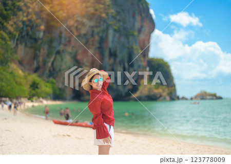 Woman tourist travel and sightseeing in Krabi, Thailand. happy traveller enjoy on beach at Phra nang Cave Beach near Railay Beach. summer trip, destination, Southeast Asia Travel and vacation concept 123778009