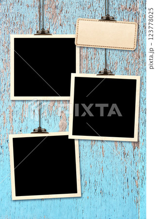 Retro Photo hanging on paper clip against wood wall. Nostalgic Picture album with old photoframes, for cherished memories, creating a unique display. Moodboard pictures album. Vintage style mood board 123778025