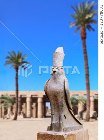 Vertical banner with granite statue of falcon God Horus, palm and ancient columns, Karnak Temple Complex, Luxor (ancient Thebes), Egypt, North Africa Vertical banner with granite statue of falcon God Horus, palm and ancient columns, Karnak Temple Complex, Luxor (ancient Thebes), Egypt, North Africa 123778031