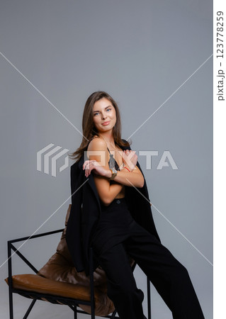 Businesswoman removing jacket sitting on chair with closed eyes 123778259