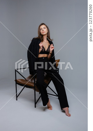 Businesswoman removing jacket sitting on chair with closed eyes Businesswoman removing jacket sitting on chair with closed eyes 123778260