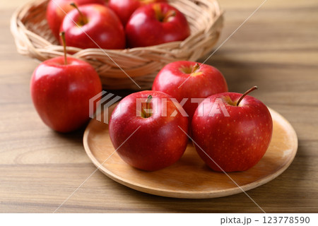 Red apple fruit (Gala apple) on wooden plate with wooden background 123778590
