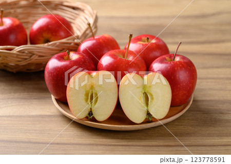 Red apple fruit (Gala apple) on wooden plate with wooden background Red apple fruit (Gala apple) on wooden plate with wooden background 123778591