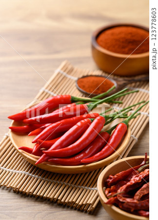 Fresh red chili peppers and chili powder on wooden background, Food ingredient 123778603