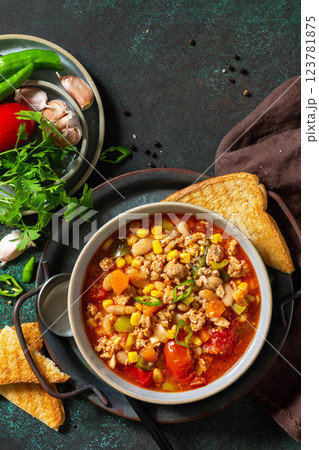 Traditional mexican food. Chili con carne, minced meat with vegetables on dark stone table. Top view flat lay. Copy space. 123781875