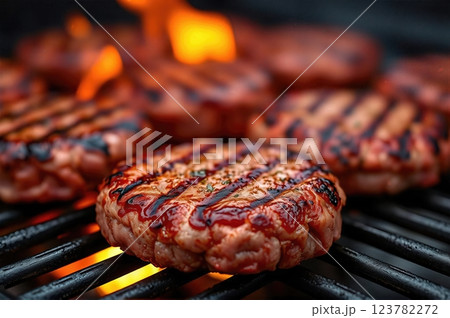 Succulent Flame-Grilled Gourmet Beef Patties Sizzling on Open Barbecue with Rising Flames A Culinary Masterpiece in Premium Food Photography 123782272