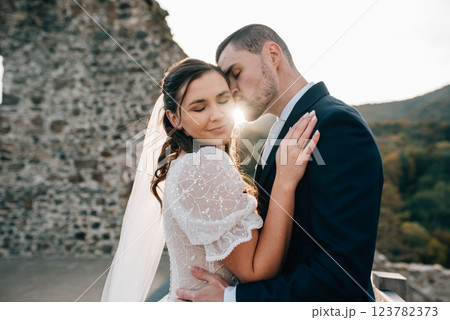Portrait of husband kissing beautiful bride. Portrait of husband kissing beautiful bride. 123782373