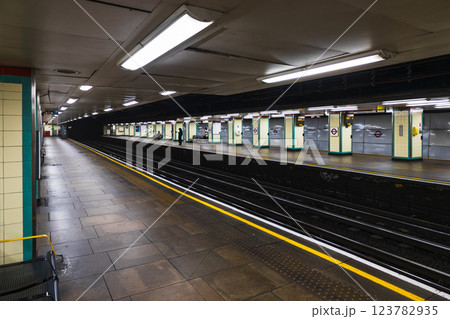 Underground train station with a long empty platform and waiting area Underground train station with a long empty platform and waiting area 123782935