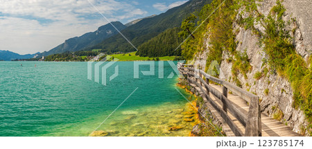wooden walkway by the rock around Lake Wolfgangsee, Sankt Wolfgang, Austria wooden walkway by the rock around Lake Wolfgangsee, Sankt Wolfgang, Austria 123785174