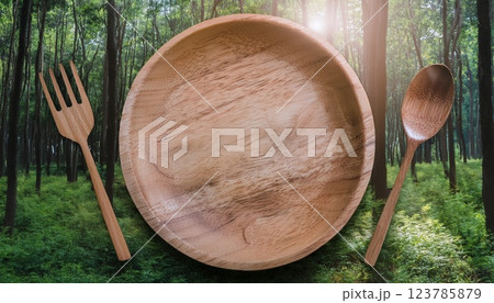 森の背景に木製のお皿とカトラリー 森の背景に木製のお皿とカトラリー 123785879