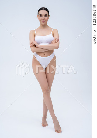 Pretty long-haired young caucasian woman in white underwear Pretty long-haired young caucasian woman in white underwear 123786149
