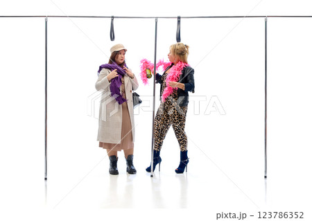 Stylish woman in leopard outfit talking to elegant passenger while holding bottle against white studio background. Stylish woman in leopard outfit talking to elegant passenger while holding bottle against white studio background. 123786352