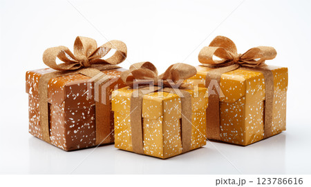 Three golden holiday gold gift boxes in various sizes adorned with bows for a luxurious celebration, special occasion. Golden 123786616