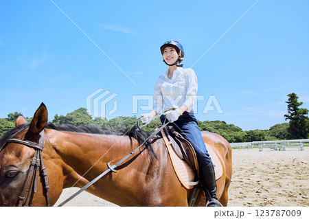 馬に乗って乗馬の練習をする女性 123787009