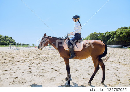 馬に乗って乗馬の練習をする女性 123787025