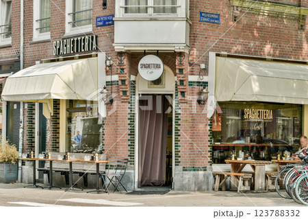 A picturesque Spaghetteria showcasing inviting outdoor seating. Modern architecture meets classic aesthetics, enhancing the urban dining experience. 123788332