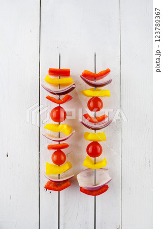 Vegetable kebab on skewers on a light wooden background 123789367