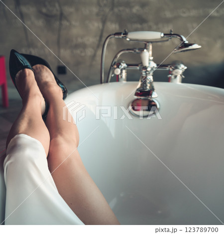 Woman feet high heels shoes in bathrobe at home, closeup 123789700