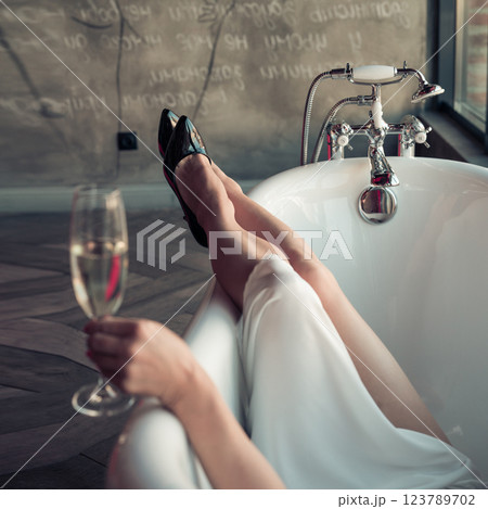 Woman feet in bathrobe at home, closeup 123789702