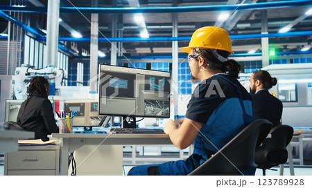 Photovoltaics factory specialist building models of renewable energy generators. Solar panels manufacturing plant technician building environmentally safe solar cells, camera A 123789928