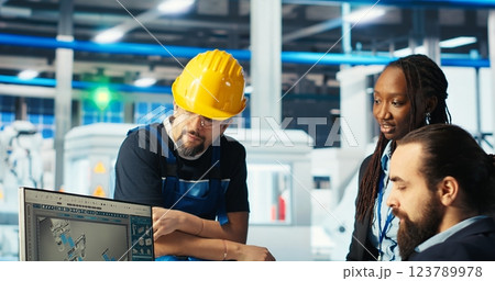Photovoltaics factory manager gives task to worker after monitoring system performance. Solar panels manufacturing plant supervisor sends engineer to improve energy production and efficiency, camera B Photovoltaics factory manager gives task to worker after monitoring system performance. Solar panels manufacturing plant supervisor sends engineer to improve energy production and efficiency, camera B 123789978