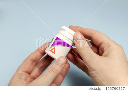 Famale hand holding a bottle of pills. Prescription medication Famale hand holding a bottle of pills. Prescription medication 123790327
