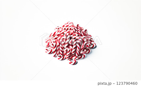 A small pile of neatly rearranged red and white striped candy canes viewed from a slightly elevated angle on a plain white background. This organized heap highlights the candy canes' colorful and 123790460