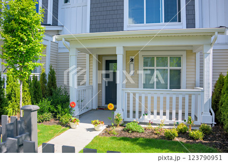 Residential house with open patio under the porch on sunny spring day 123790951