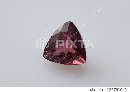 Natural Purple-Pink Tourmaline Trilliant Cut Gemstone with Glossy Surface and Intricate Inclusions Natural Purple-Pink Tourmaline Trilliant Cut Gemstone with Glossy Surface and Intricate Inclusions 123791641