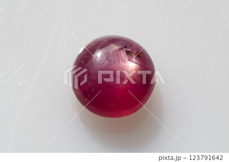 Natural Round Cabochon Red Ruby Gemstone Displaying Rare Six-Ray Star Pattern Natural Round Cabochon Red Ruby Gemstone Displaying Rare Six-Ray Star Pattern 123791642