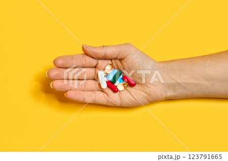 Various pills of different colors and shapes at hand 123791665