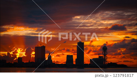 Batumi, Adjara, Georgia. View From Sea Beach To Cityscape With Modern Urban Architecture, Skyscrapers And Tower. Embankment At Sunset Sunrise. Bright Evening Sky In Yellow, Orange And Red Colors Batumi, Adjara, Georgia. View From Sea Beach To Cityscape With Modern Urban Architecture, Skyscrapers And Tower. Embankment At Sunset Sunrise. Bright Evening Sky In Yellow, Orange And Red Colors 123791817